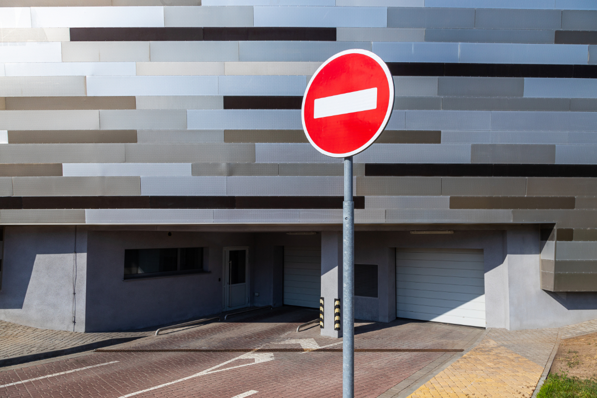Halt road sign before underground parking space for vehicles with automatic service system. Photo with depth of field